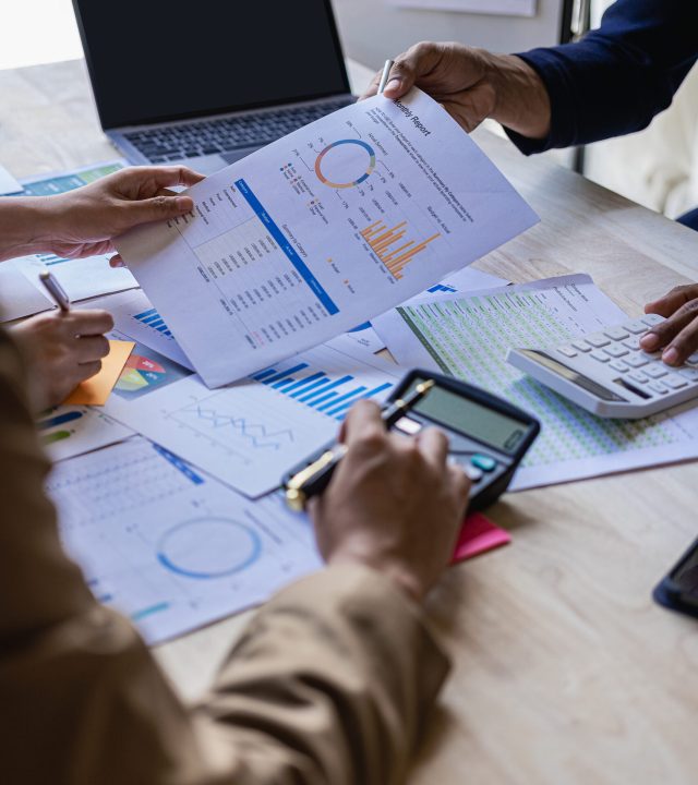 vertical image business financial analyst on investment project planning digital tablet during discussion at corporate meeting showing successful teamwork