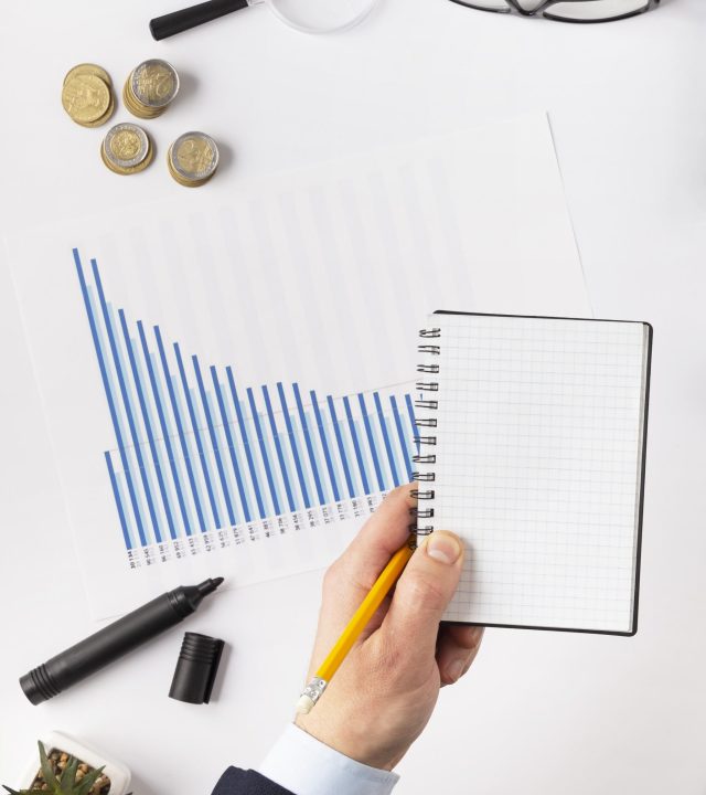 top view finances elements composition with empty notepad