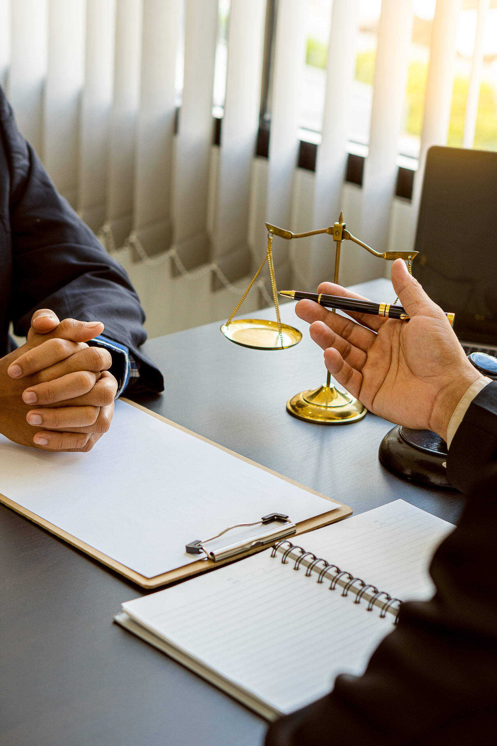 businessmen and lawyers discussing contract businessman and lawyer discussing contract documents sitting at a table legal concept consultants with hammers and scales placed next to each other with a v