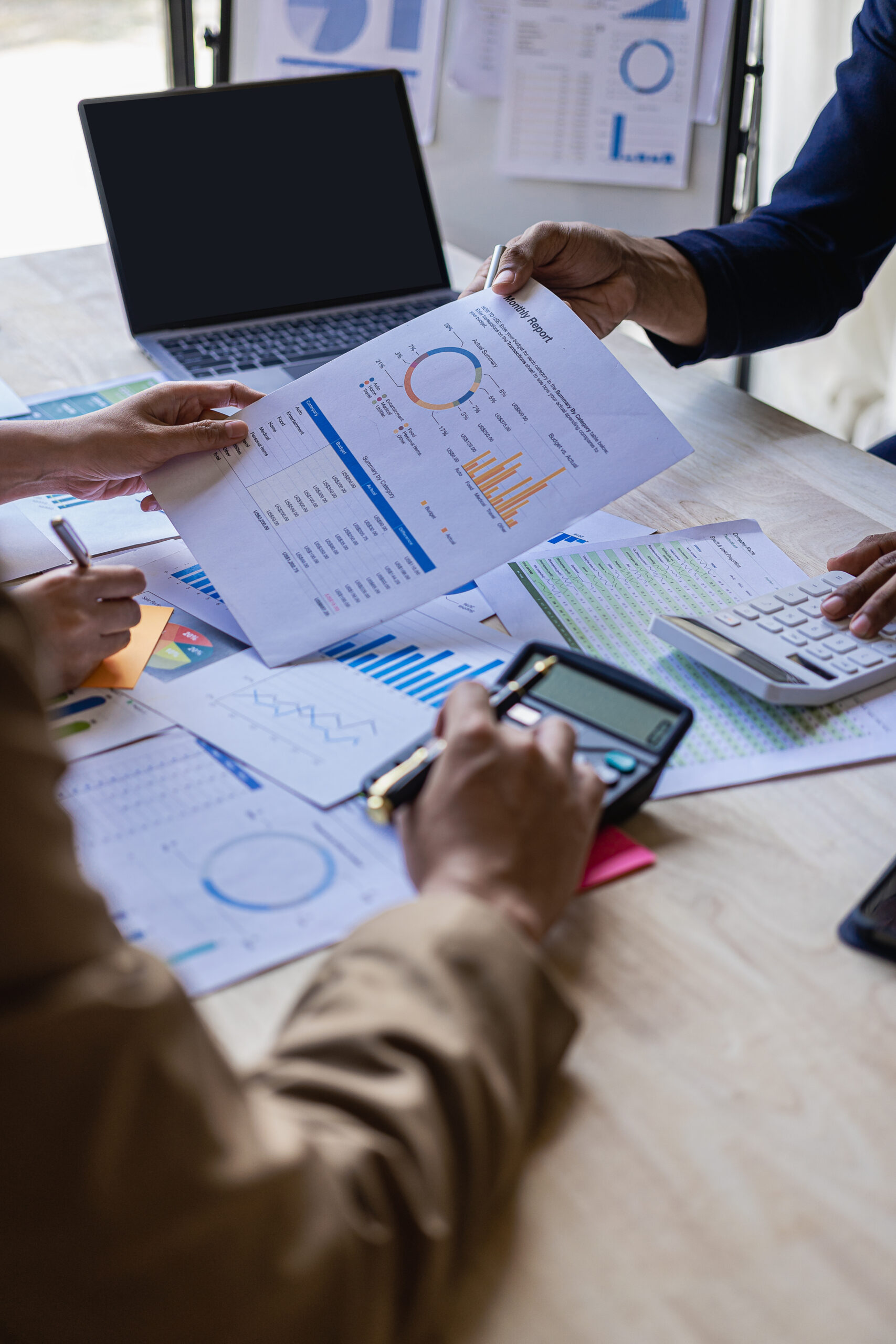 vertical image business financial analyst on investment project planning digital tablet during discussion at corporate meeting showing successful teamwork