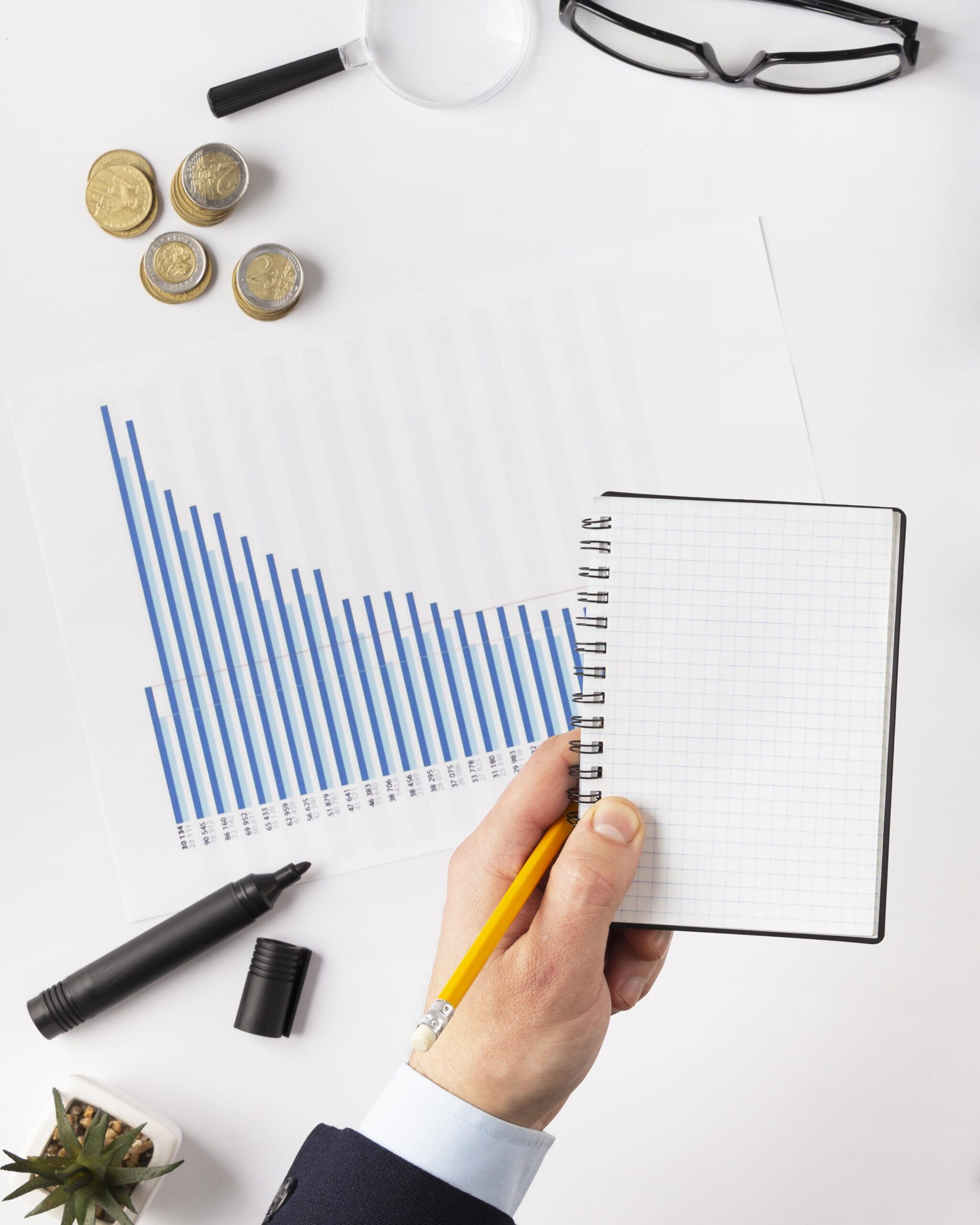 top view finances elements composition with empty notepad